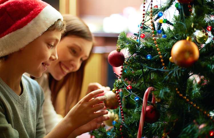 Guideposts: Mother and son smile as they decorate the Christmas tree